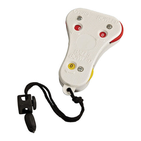 A white handheld cricket umpire counter with buttons and dials for counting overs, balls bowled, and wickets, attached to a black wrist strap with an adjustable toggle.