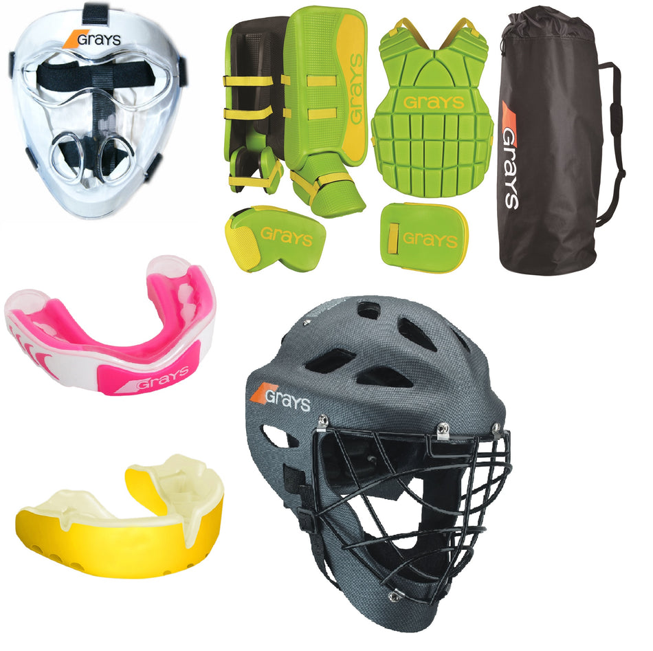 A collection of field hockey goalie gear, including two masks, green protective pads, chest guard, arm guards, a black equipment bag, and two colored mouthguards (pink and yellow).