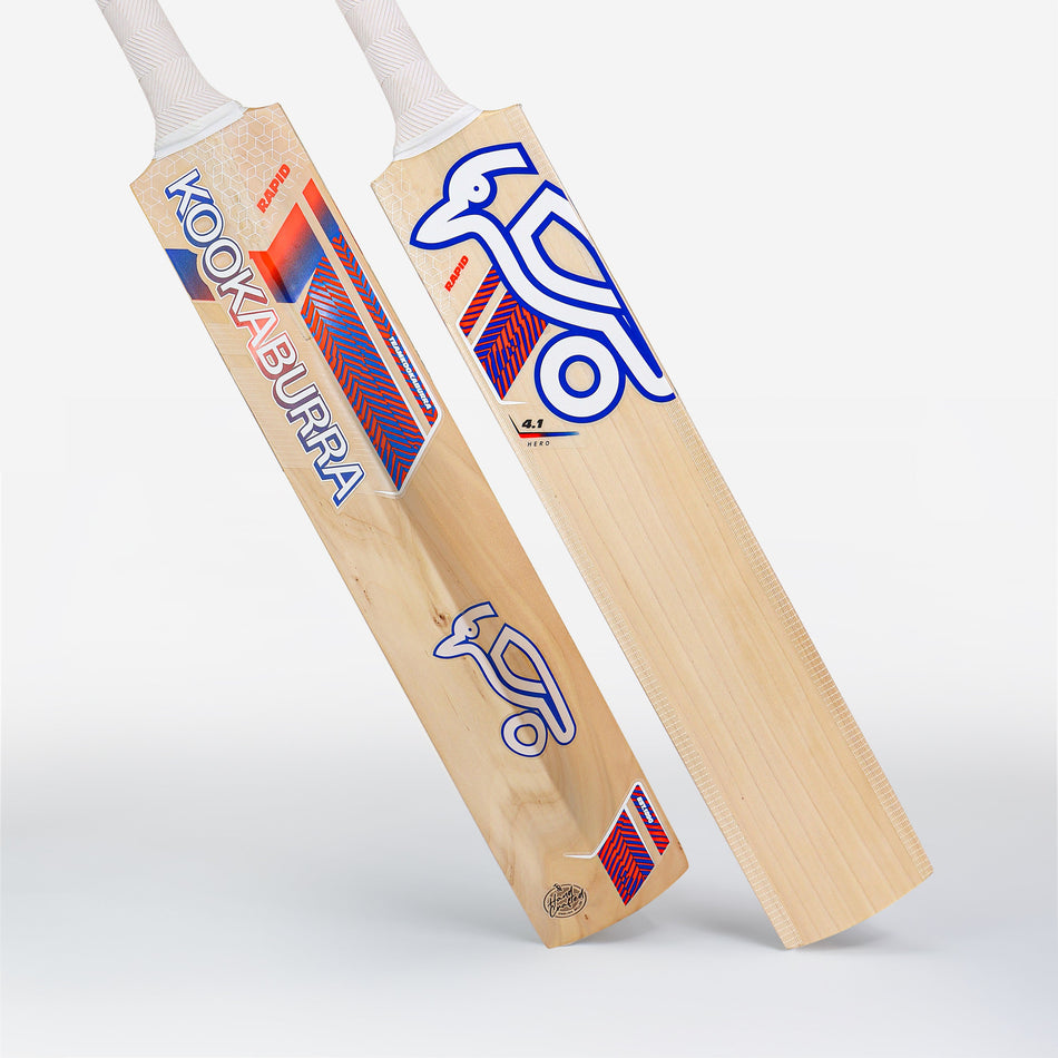 Two Kookaburra Rapid 4.1 Hero Junior Cricket Bats 2026 stand upright, showing their front and back. Both display blue, red, and white branding with the kookaburra logo on light willow and feature white handles.