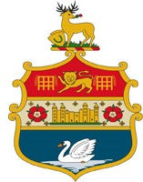 A colorful heraldic crest featuring a gold deer atop, a lion, red roses, and buildings in the center, and a white swan on blue water at the bottom.