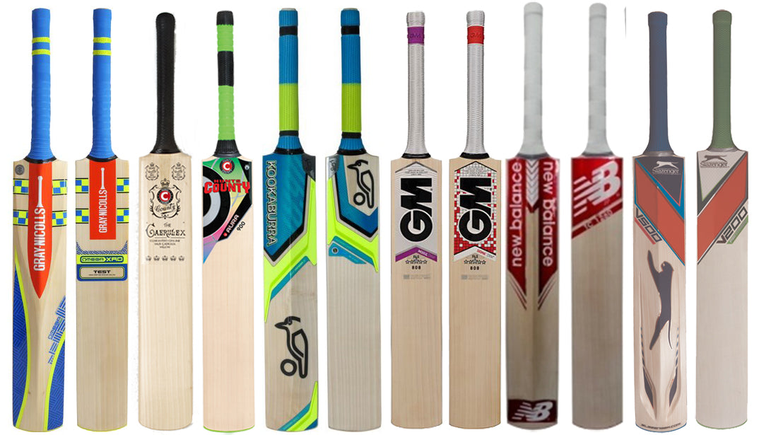 A row of eleven cricket bats, each featuring different designs, colors, and brand logos, standing upright against a white background.