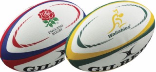 Two rugby balls side by side: one with the England Rugby logo and red, white, and blue stripes; the other with the Wallabies logo and yellow and green stripes.