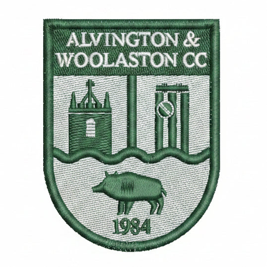 Green and white embroidered patch with ALVINGTON & WOOLASTON CC at the top, cricket stumps, a building, a wild boar, and the year 1984 at the bottom.