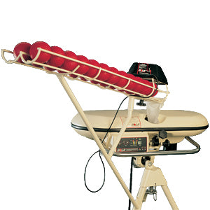 A baseball pitching machine with a white frame, holding several red balls in a rack, and a control panel on its base.
