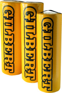 Three yellow Gilbert-branded rugby post protectors standing upright side by side, with the brand name printed vertically in large black letters.