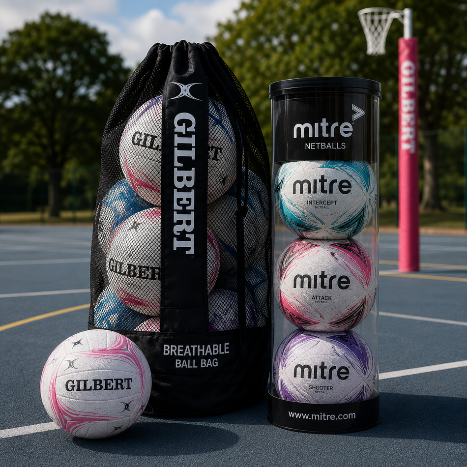 Twelve white and blue Mitre soccer balls are arranged beside a black Mitre-branded mesh bag for carrying balls.
