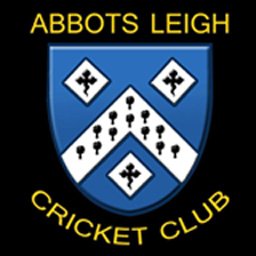 Abbots Leigh Cricket Club logo featuring a blue shield with a white chevron pattern and black symbols, surrounded by the club name in yellow text on a black background.