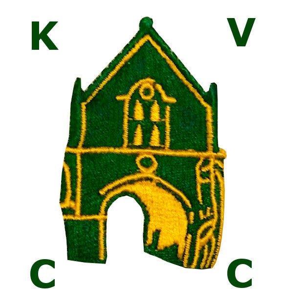 A green and yellow embroidered church with an arched doorway is centered between the letters K, V, C, and C, each placed in a corner around the image.