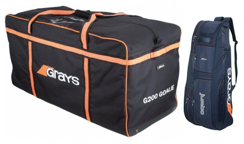 Two large sports bags: one black and orange rectangular Grays G200 GOALIE bag with wheels, and one navy blue Grays jumbo stick bag standing upright.