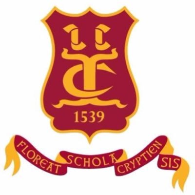 A maroon and gold school crest with a lion symbol, the initials C C, the year 1539, and a ribbon below reading Floreat Schola Cryptiensis.