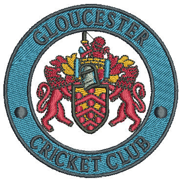 Circular embroidered patch with a coat of arms featuring two red lions, a helmet, and shield. Blue border reads GLOUCESTER CRICKET CLUB in uppercase letters.