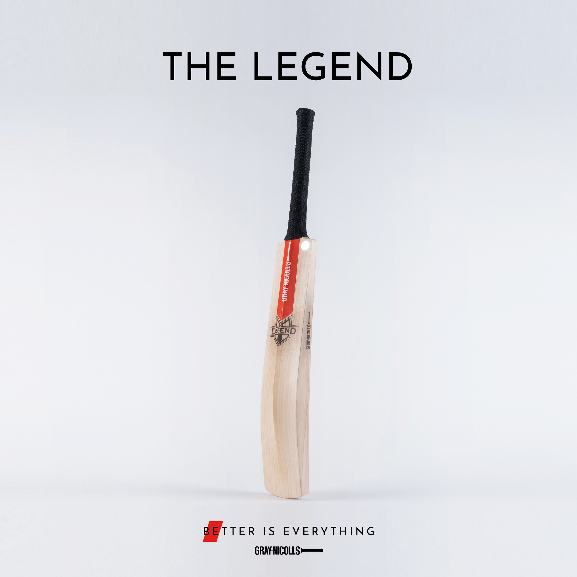A cricket bat with a red and white Gray-Nicolls label stands upright on a plain background. The text above reads THE LEGEND, and below is the slogan Better is Everything.