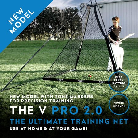 A person with a cricket bat stands beside The V Pro 2.0 by The V—a large V-shaped training net on grass, featuring precision training, zone markers, and tools for better batting skills. Text highlights: NEW MODEL – THE V PRO 2.0.