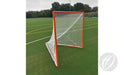 A Harrod Sport Freestanding Competition Lacrosse Goal, featuring a white net and orange frame, stands on a green artificial turf field marked with yellow and white lines, ready for play. In the background, trees and a fence are visible under a cloudy sky.