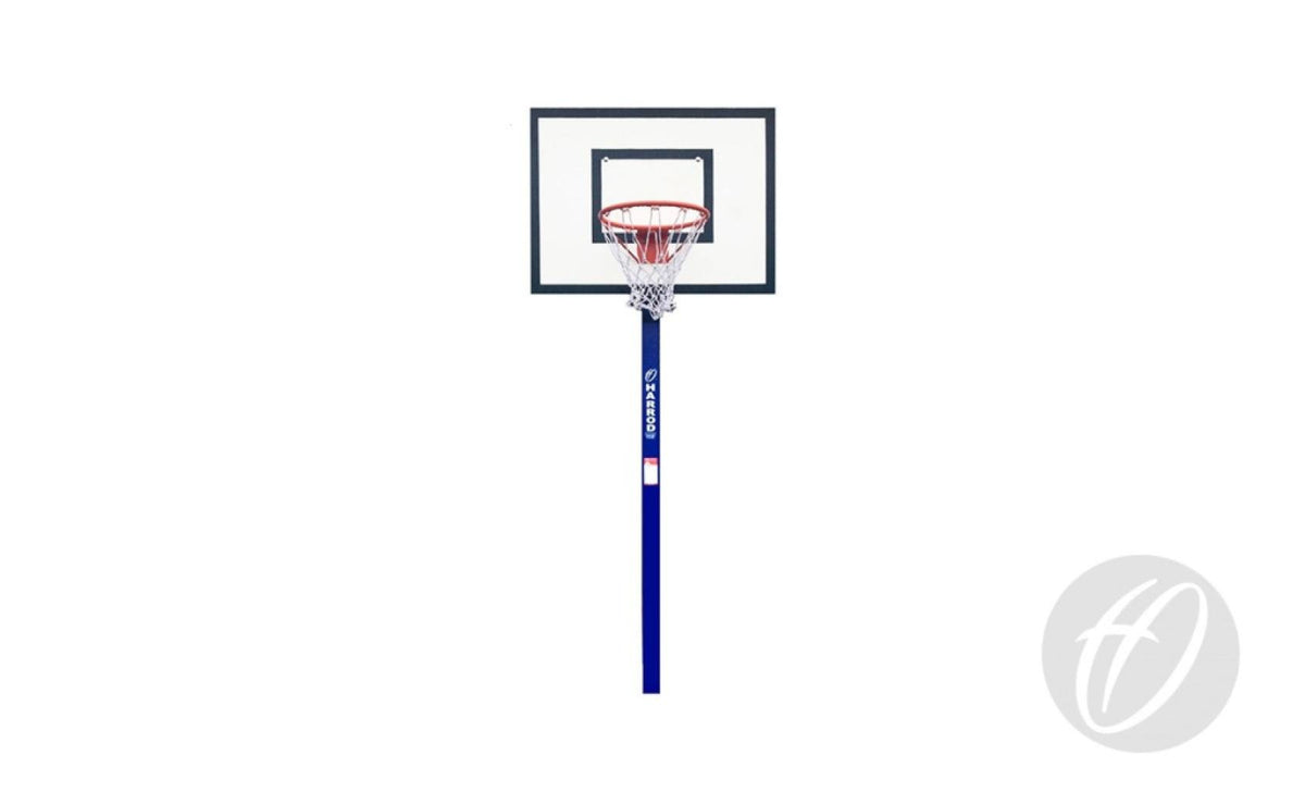A freestanding Harrod Sport Mini Basketball Goal features a clear backboard, regulation size ring, and white net mounted on a blue pole. The lower right corner of the white background displays a faint circular logo.