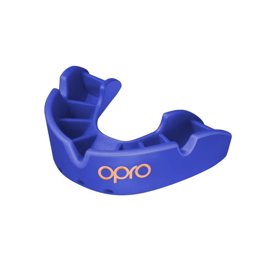 The OPRO Bronze Self Fit Mouthguard by Opro is a blue mouthguard with grooved sections and "opro" printed in white, designed to protect teeth during sports activities.