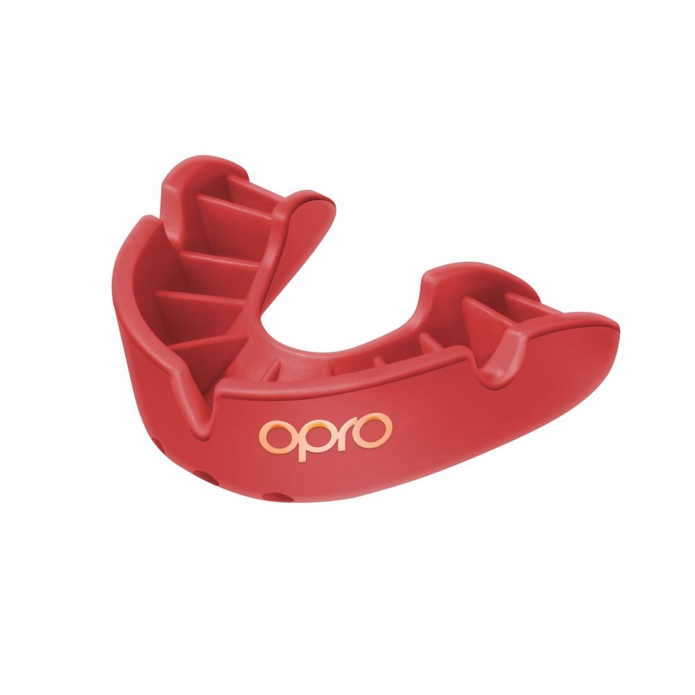 The OPRO Bronze Self Fit Mouthguard by Opro is a red mouthguard featuring a yellow logo on the front. It fits over the upper teeth to provide enhanced protection during athletic activities.
