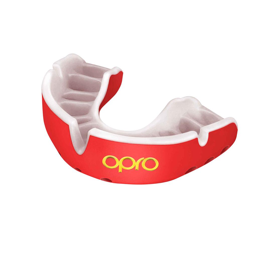 The OPRO Gold Self-Fit Mouthguard by Opro features a red and white design with "opro" in yellow on the front. It fits over upper teeth for protection during sports, making it ideal as a competition level gum shield.
