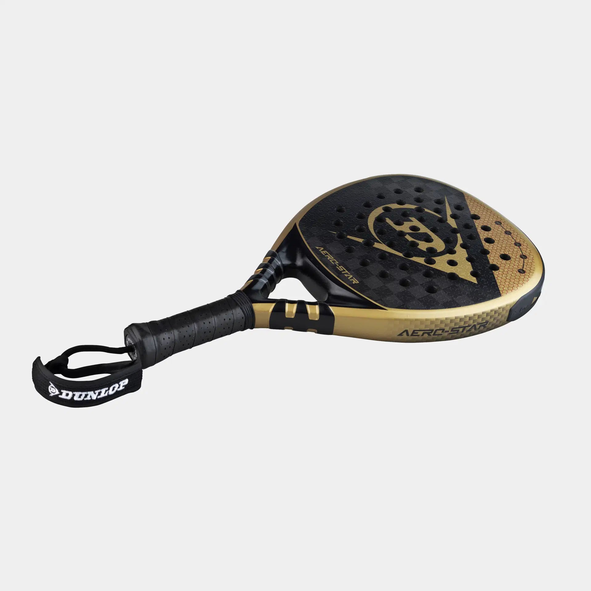The Dunlop Aerolite Padel Racket, in black and gold, features a Hyper Gryp finish, perforated surface, textured grip, and a DUNLOP-branded wrist strap, displayed on a plain white background.