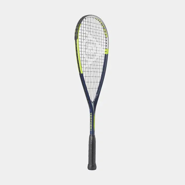 The Dunlop Tristorm Jr 25 Squash Racket features a dark blue frame with yellow accents, black grip, and white strings, shown upright against a plain light background—ideal for young squash players.