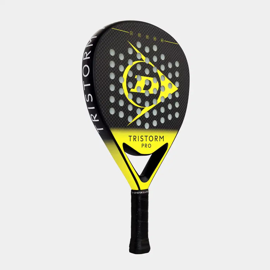 The Dunlop Tristorm Pro Padel Racket features a black and yellow graphite construction, a perforated design, a black grip handle, and is marked with a stylized P logo on the face.