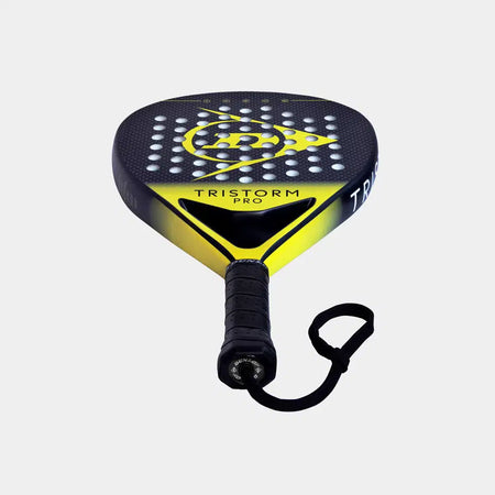The Dunlop Tristorm Pro Padel Racket features a black and yellow design, Power Frame technology, graphite construction, “TRISTORM PRO” branding, perforated surface, and wrist strap—photographed on a plain white background.