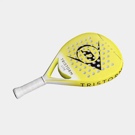 A yellow Dunlop Tristorm Lite Padel Racket with a white handle, black accents, and circular holes. The surface displays "TRISTORM" and the Dunlop logo, featuring Power Frame technology for enhanced performance.