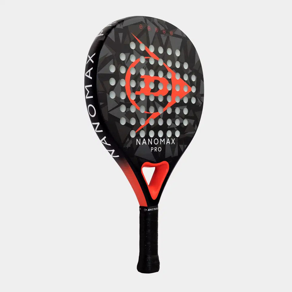 The Dunlop Nanomax Pro Padel Racket by Dunlop features a black and red design with a geometric pattern, multiple holes on the face, a hybrid headshape, and "NANOMAX PRO" printed on it, shown against a plain light gray background.