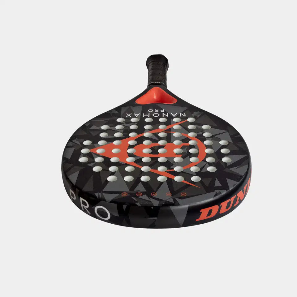 The Dunlop Nanomax Pro Padel Racket by Dunlop features a black and red geometric design, graphite frame bat, hybrid headshape, and evenly spaced holes, with "DUNLOP" on the side, shown against a plain white background.