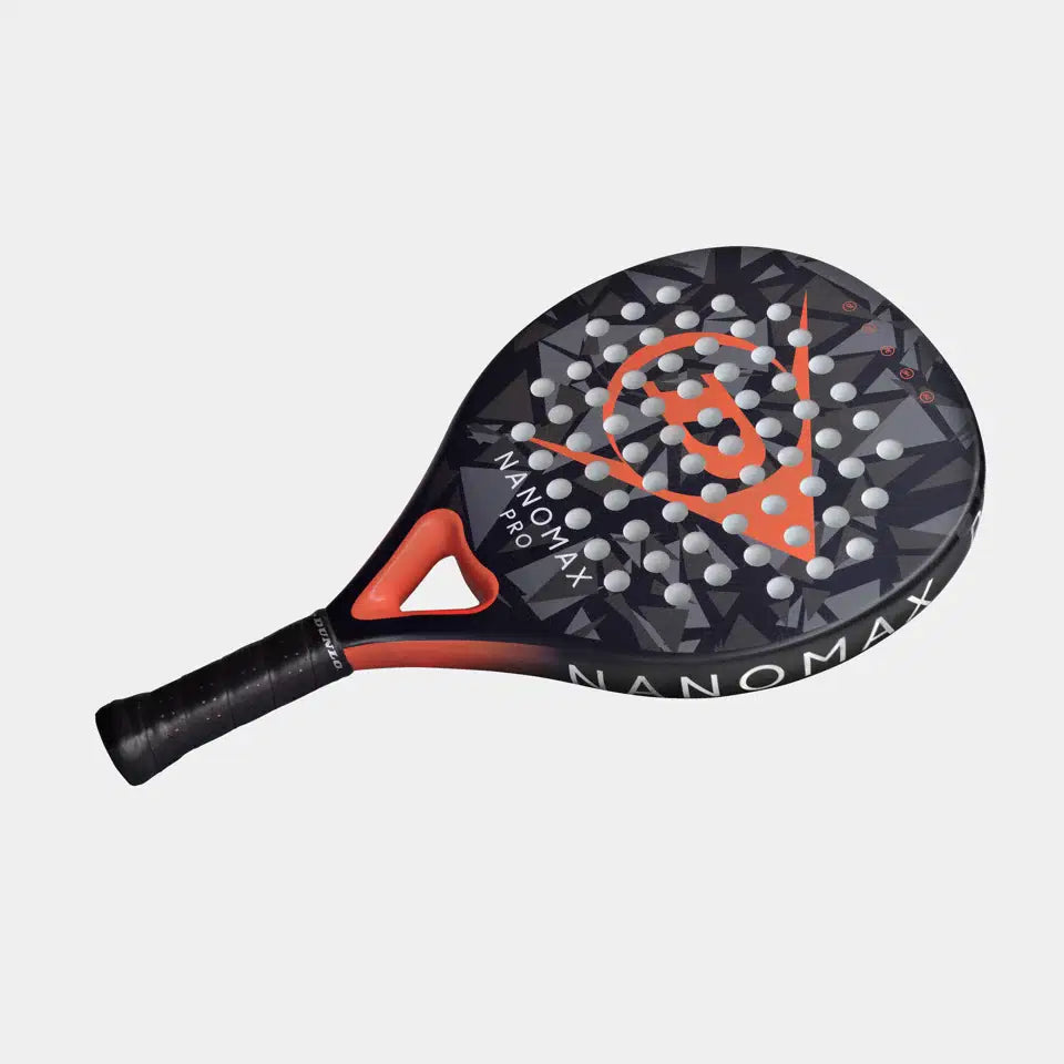 The Dunlop Nanomax Pro Padel Racket features a black and orange design with geometric patterns, circular perforations, Dunlop branding on the face and edge, a graphite frame, and Pro EVA core for enhanced performance.