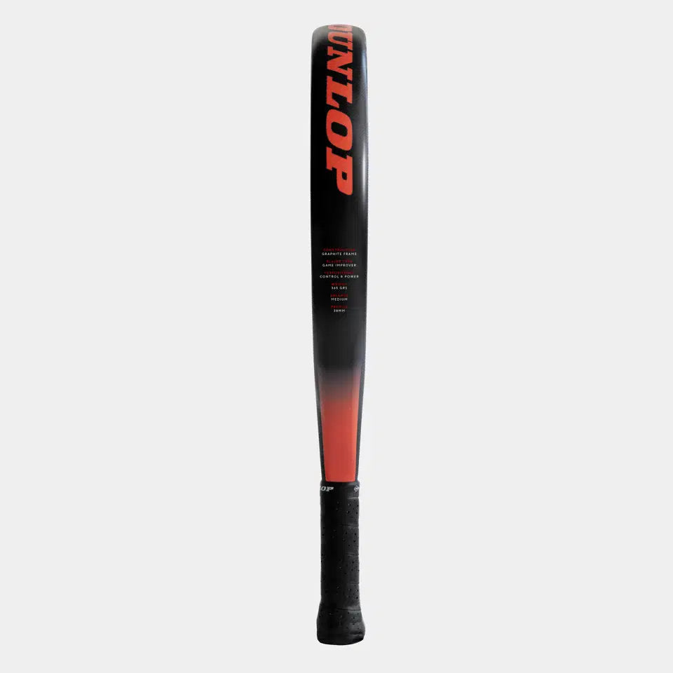 A black and red Dunlop Nanomax Pro Padel Racket stands upright, featuring the DUNLOP brand in bold red letters on the face and a textured black handle.
