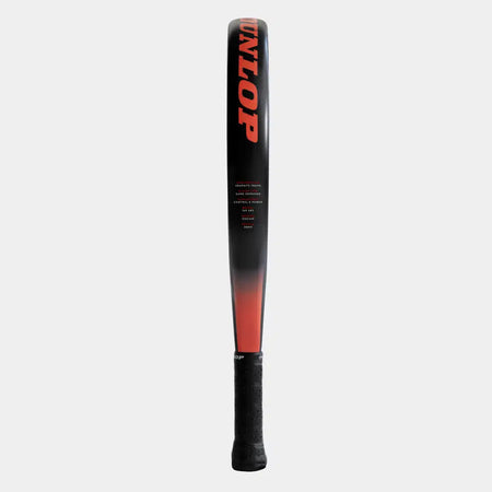 A black and red Dunlop Nanomax Pro Padel Racket stands upright, featuring the DUNLOP brand in bold red letters on the face and a textured black handle.
