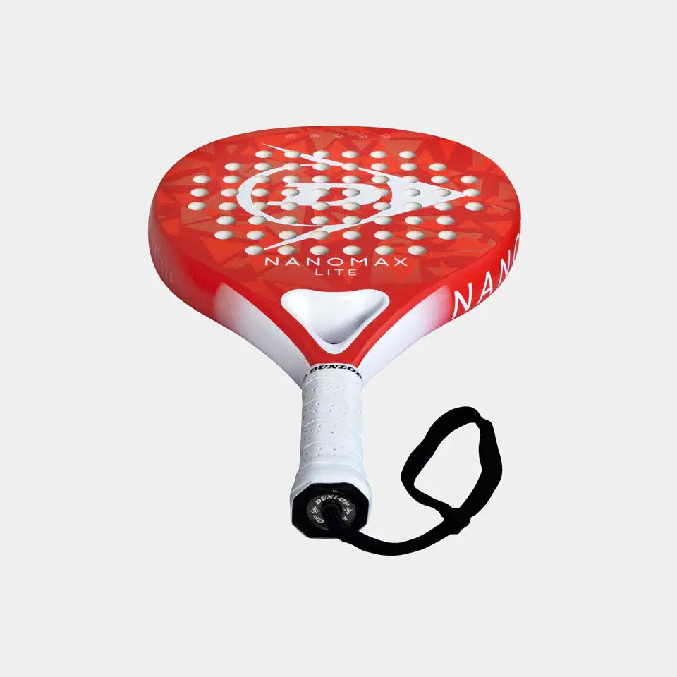 The Dunlop Nanomax Lite Padel Racket features a graphite frame, red and white design, circular hole pattern, white grip, and black wrist strap, shown against a plain light background.