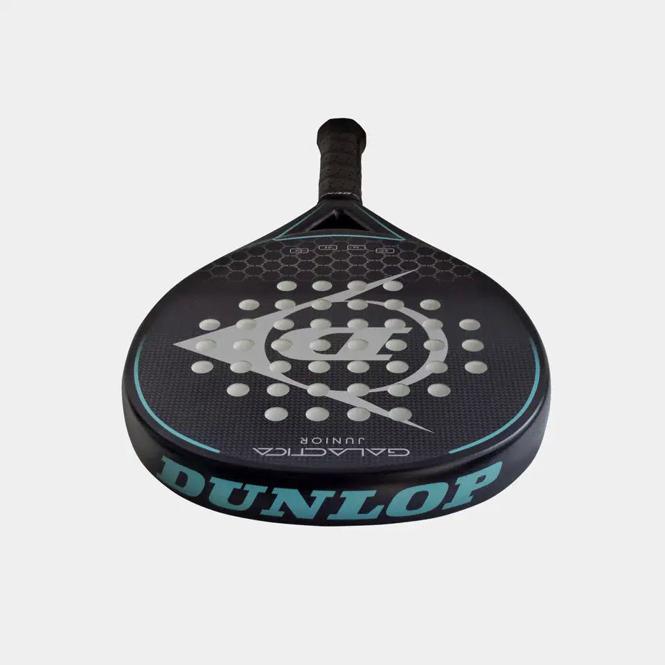 The Dunlop Galatica Junior Padel Racket features a black design with blue accents, a graphite frame, perforated face, and honeycomb pattern. Large blue Dunlop branding is printed on the side.
