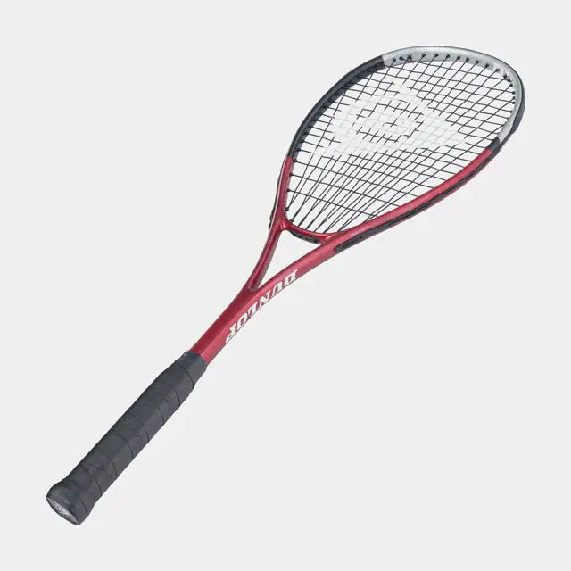 The Dunlop Tristorm Tour Squash Racket features a red and black frame, black handle, white strings, and the Dunlop logo centered on the head—perfect for beginners. Displayed against a plain light background.