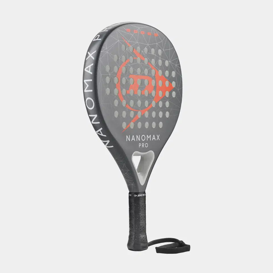 The Dunlop Nanomax Pro Padel Racket features a graphite frame, black handle, wrist strap, orange geometric design, and Pro EVA core. Shown in gray against a plain light background.