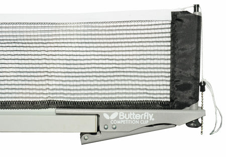 Close-up of the Butterfly Competition Clip Net & Post Set attached to a table, featuring its adjustable black and white net secured with a silver Butterfly clip and tension adjustment string on the right side. This Butterfly set delivers reliable support for intense table tennis matches.