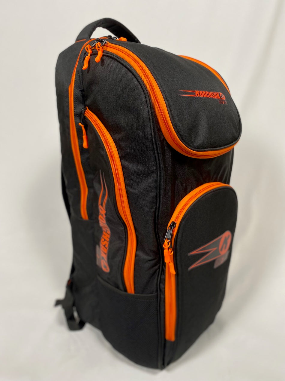 A black/orange Katchet KoachSak One2One bag with bright orange zippers, multiple compartments, and the KRONIS logo on the front pocket, shown against a plain white background.