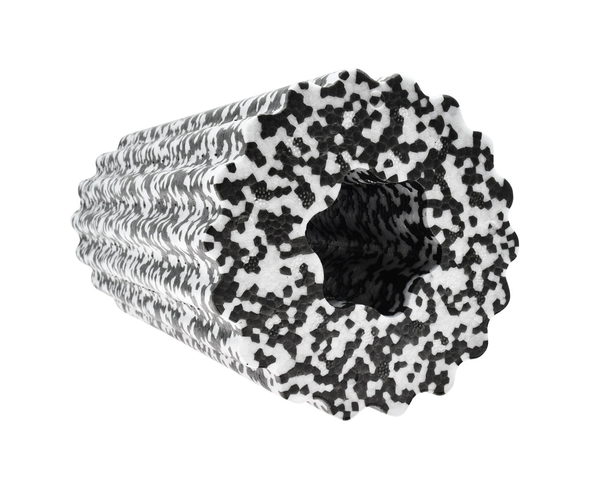 The Urban Fitness Foam Massage Roller by Urban Fitness is a black and white speckled, high-density foam roller with a textured wavy surface and hollow center for deep tissue relief, shown on a white background.