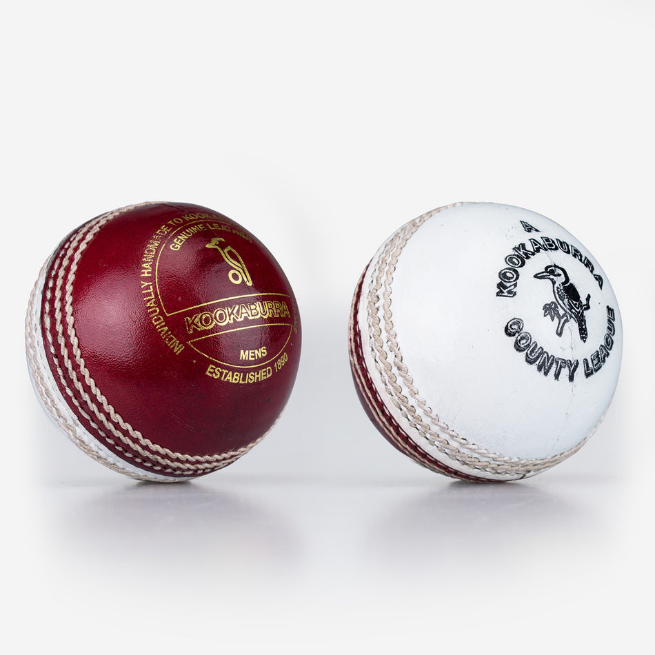 Two Kookaburra County League Cricket Balls, one red and one white, are displayed side by side on a white background, each featuring hand stitching and branded logos.