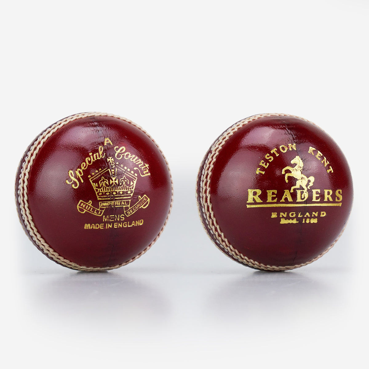 Two Readers Special County Imperial Crown cricket balls in brown leather with gold embossed logos, white stitching, and a glossy finish—ideal for Premier League cricket—are shown against a white background.