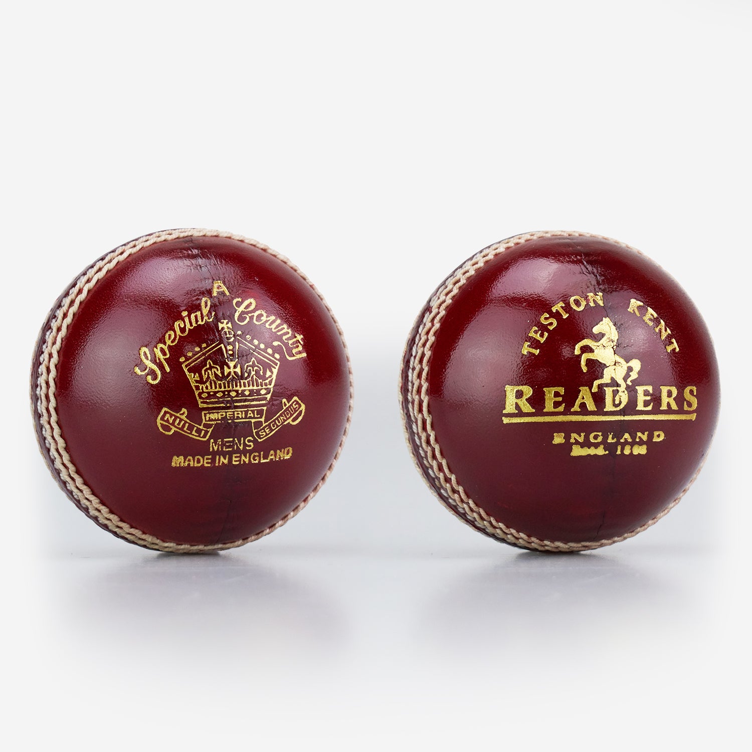 Two Readers Special County Imperial Crown cricket balls in brown leather with gold embossed logos, white stitching, and a glossy finish—ideal for Premier League cricket—are shown against a white background.