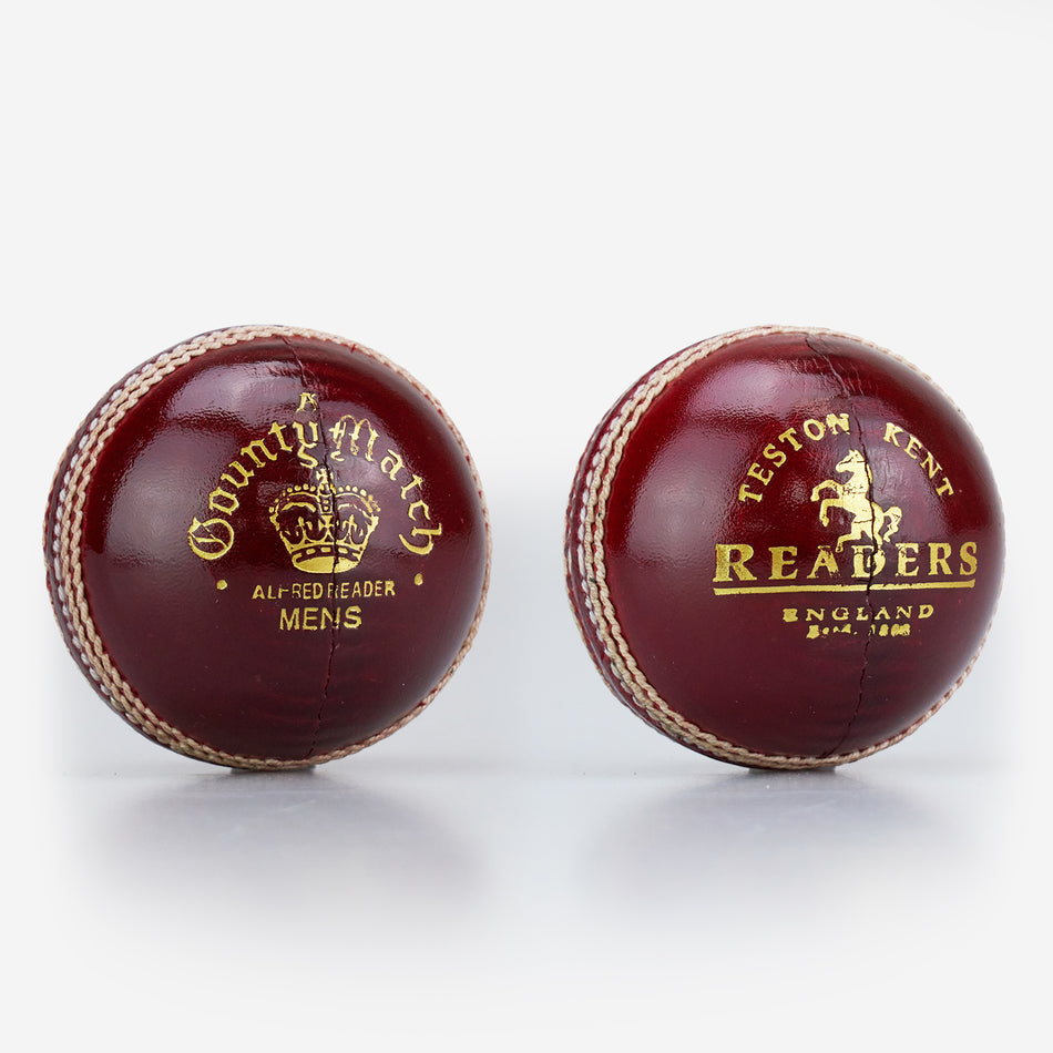 Two dark red Readers leather cricket balls with gold text. The left is a Readers County Match Cricket Ball; the right reads "Teston Kent, Readers, England, Estd. 1808.