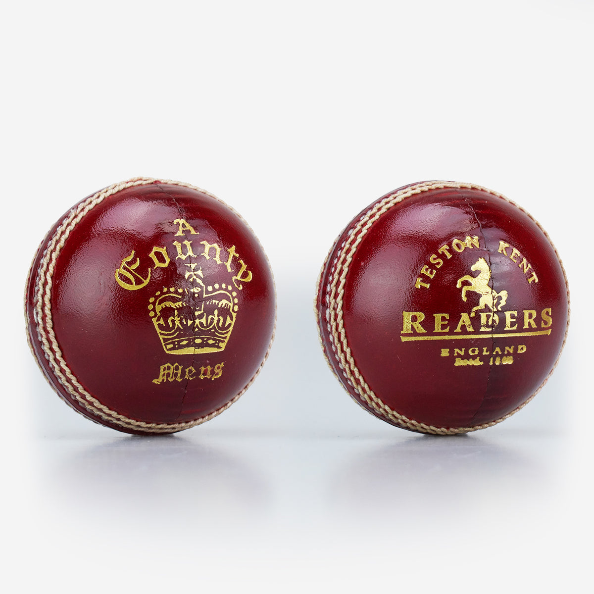 Two red, hand-stitched cricket balls by Readers: one is the County Crown Cricket Ball with "A County Meus" and a crown; the other says "Teston Kent Readers England Estd. 1808" with a horse emblem. Both made from premium English leather.
