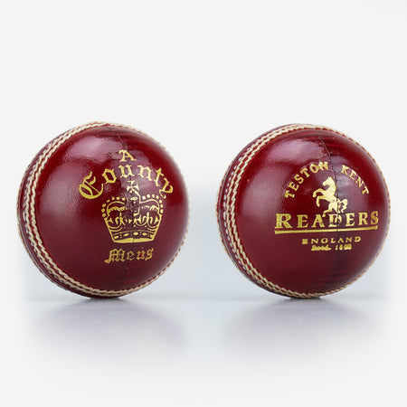 Two red, hand-stitched cricket balls by Readers: one is the County Crown Cricket Ball with "A County Meus" and a crown; the other says "Teston Kent Readers England Estd. 1808" with a horse emblem. Both made from premium English leather.