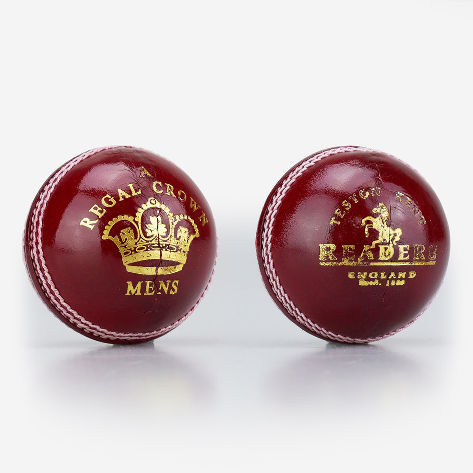 Two red Readers Regal Crown Cricket Balls, crafted from alum tanned leather with white hand-stitched seams and gold crown logos, are shown on a white background.
