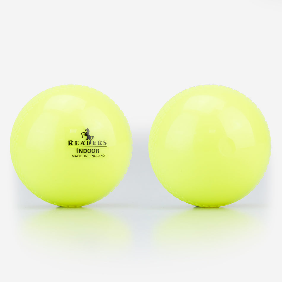 Two yellow Readers Indoor 4oz Cricket Balls are side by side on a white surface. The left ball shows the Readers logo, highlighting it as a lightweight plastic option from Readers for coaching or indoor cricket play.