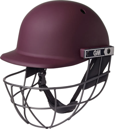The Gunn & Moore Maestro Edge Cricket Helmet in maroon features a metal faceguard, chin strap, breathable design, and the GM logo, providing superior impact protection for players.