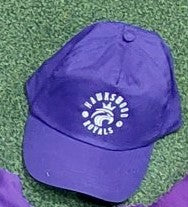 The Hawkeswood Royals Cap by Martin Berrill Sports is a 5-panel purple cap with "Hawkswood Royals" and a crown logo, shown on green artificial turf.