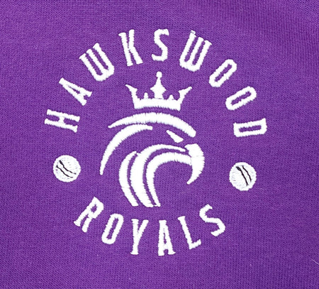The Hawkeswood Royals Tee Shirt by Martin Berrill Sports features an embroidered white logo with a crowned lion’s head, "HAWKSWOOD ROYALS" text, and baseballs on a purple Neoteric fabric.
